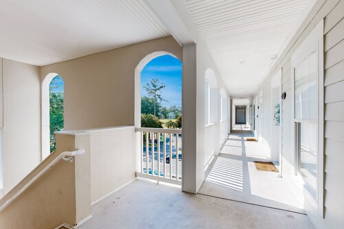 On-site golf condo with scenic balcony, pool access, AC, W/D, & full kitchen