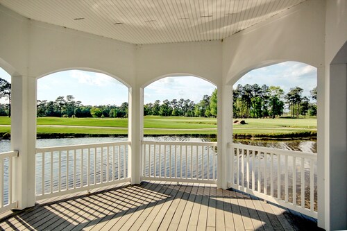 On-site golf condo with scenic balcony, pool access, AC, W/D, & full kitchen