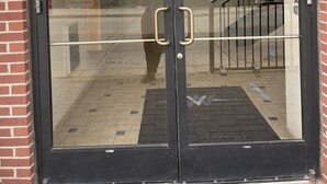 A double glass door with a metal handle, set in a brick wall. - One of a kind Luxury Loft (Dearborn)