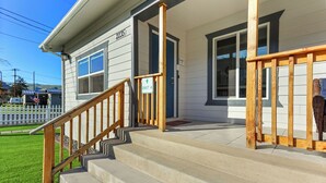 A two-story house with a front porch, a staircase, and a sign indicating 'Unit A'. - Amber Nook! Always clean, and build to be comfortable! (The Dalles)