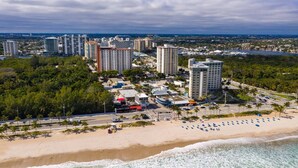 A coastal cityscape with high-rise buildings, a beach, and a marina. - Prime Central Beach Location! 2BR Condo, Pool, Bar, Game Room, at Fort Lauderdale Beach Resort (Fort Lauderdale)