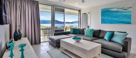 A modern living room with a sofa, coffee table, and decorative items.