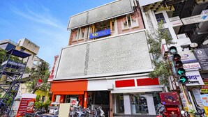 A multi-story building with a prominent 'fab hotels' sign, a visible entrance, and a traffic light. - Fabhotel Silver Inn Ii (Nashik)