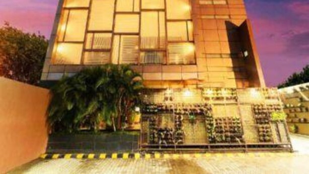 Un edificio moderno con fachada de vidrio y una entrada destacada.