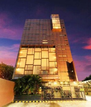 A modern building with a glass facade and a prominent entrance. - Fabhotel Prime Capitol Residency (Ranchi)