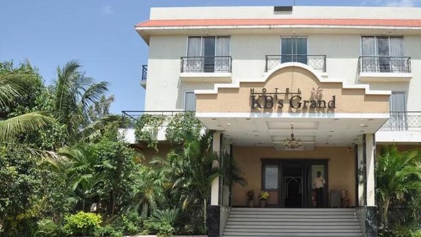 A hotel with a sign reading "KB's Grand" and a staircase leading to the entrance. - Fabhotel Prime Kb'S Grand (Rahata)