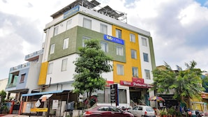 A multi-story hotel with a sign for 'Padmawati Palace' and 'Tab Hotels.'