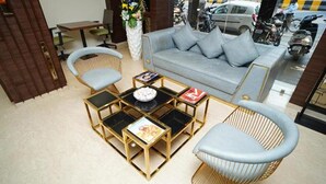 A modern living area with a sofa, two armchairs, and a coffee table. - Fabhotel Prime Orange Tree (Nagpur)