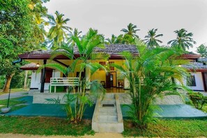 Traditional architecture meets lush surroundings in this charming two-story building.