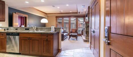 A spacious kitchen with wooden cabinets, a built-in dishwasher, and a large island.