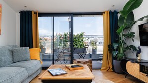 Un salon moderne avec un canapé, une table basse et une vue sur le balcon.