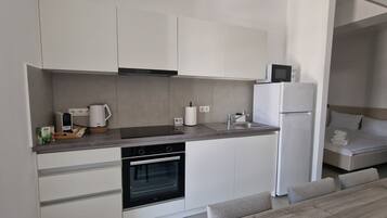 Deluxe Studio | Private kitchen | Full-size fridge, microwave, oven, stovetop