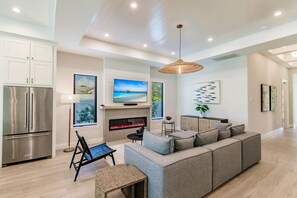 Smart TV, lareira, livros, aparelho de som