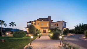 A large, multi-story house with a well-maintained lawn and a paved driveway leading to the entrance. - Natali Luxury Villa (Iason Villas), 9 Bedrooms (Chania)