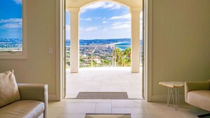 A room with a view of a cityscape and beach through an open doorway. - La Jolla Dream Stay: Ocean, Bay, Pool (San Diego)
