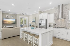 Enjoy cooking in this well-equipped kitchen with a central island, gas stove, and refrigerator.