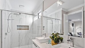 Bathtub, hair dryer, towels, shampoo