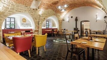 A restaurant with brick walls, arched ceilings, and hexagonal floor tiles.