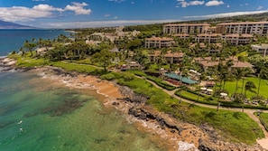 A resort with beachfront properties, a swimming pool, and lush landscaping. - Wailea Beach Villas M312 3 Bedroom Condo (Kihei)