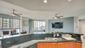 A modern kitchen with a large island, built-in appliances, and a view to the outside. - Luxe Resort Condo - 2 Mi to Daytona Beach! (Holly Hill)
