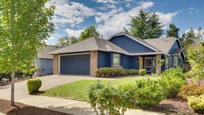 A two-story house with a garage, a front yard with a lawn, and a driveway. - Portland Area Retreat in North Wine Country! (Tualatin)
