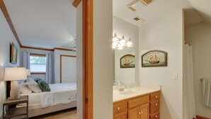 A bedroom with a bed, bedside table, lamp, and a window with curtains. - Waterfront Home Near Wilson Lake w/ Covered Porch! (Killen)