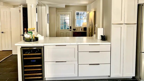 A modern kitchen with white cabinetry, a built-in oven, and a countertop with a popcorn container. - Charming Hydrangea Cottage in Sewickley Village 4bd/1.5 b - 20 min to Pittsburgh (Sewickley)