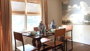 A dining area with a wooden table set for four, featuring traditional Chinese porcelain and glassware. - Charming Hydrangea Cottage in Sewickley Village 4bd/1.5 b - 20 min to Pittsburgh (Sewickley)