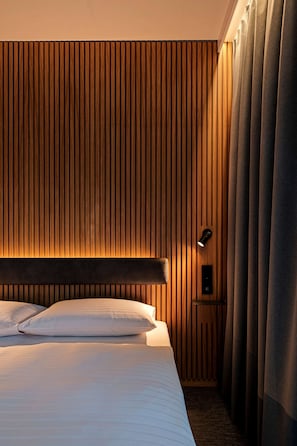 Hypo-allergenic bedding, desk, laptop workspace, blackout curtains