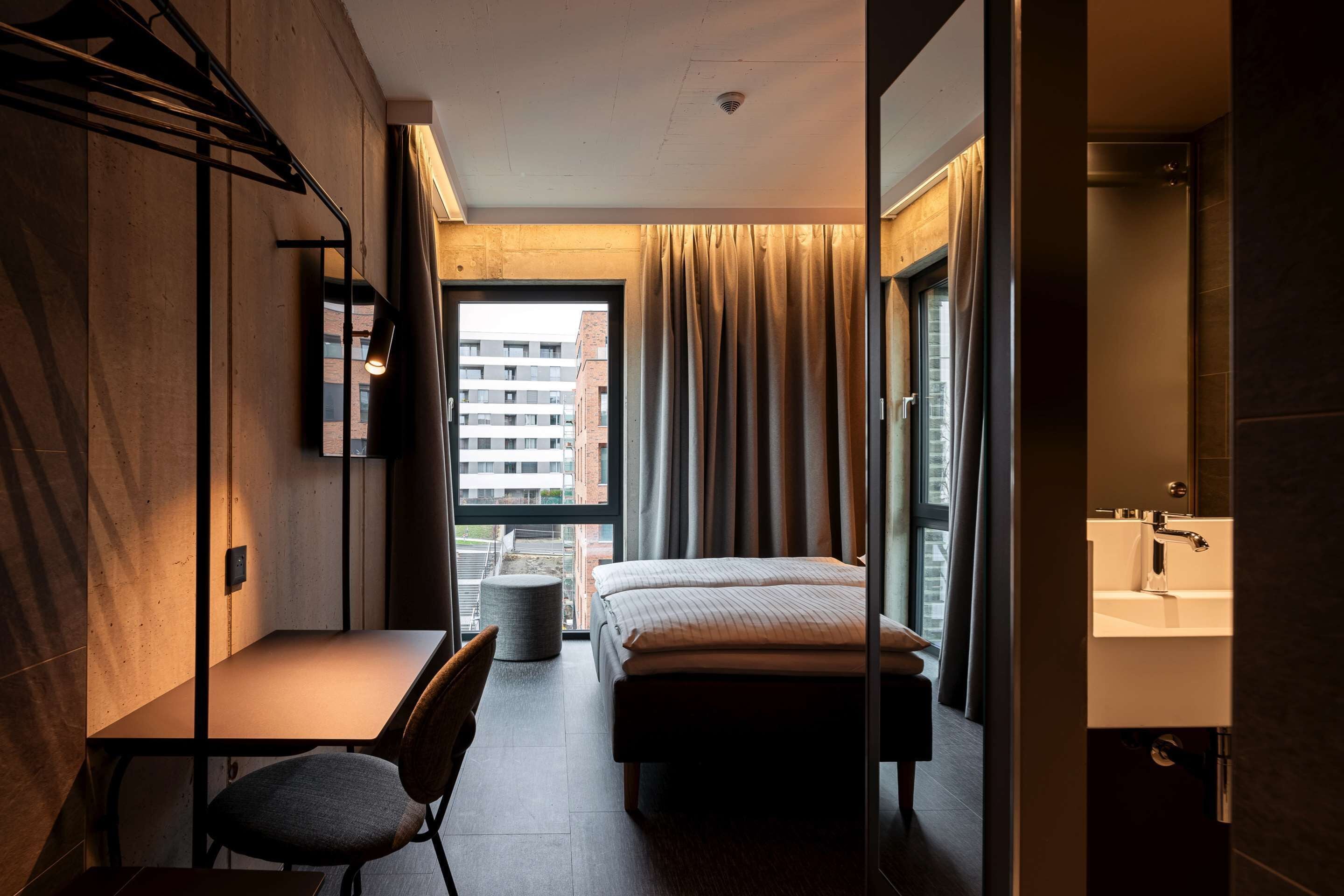 Hypo-allergenic bedding, desk, laptop workspace, blackout drapes