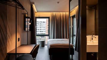 Hypo-allergenic bedding, desk, laptop workspace, blackout drapes