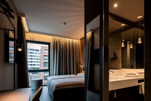 Hypo-allergenic bedding, desk, laptop workspace, blackout drapes
