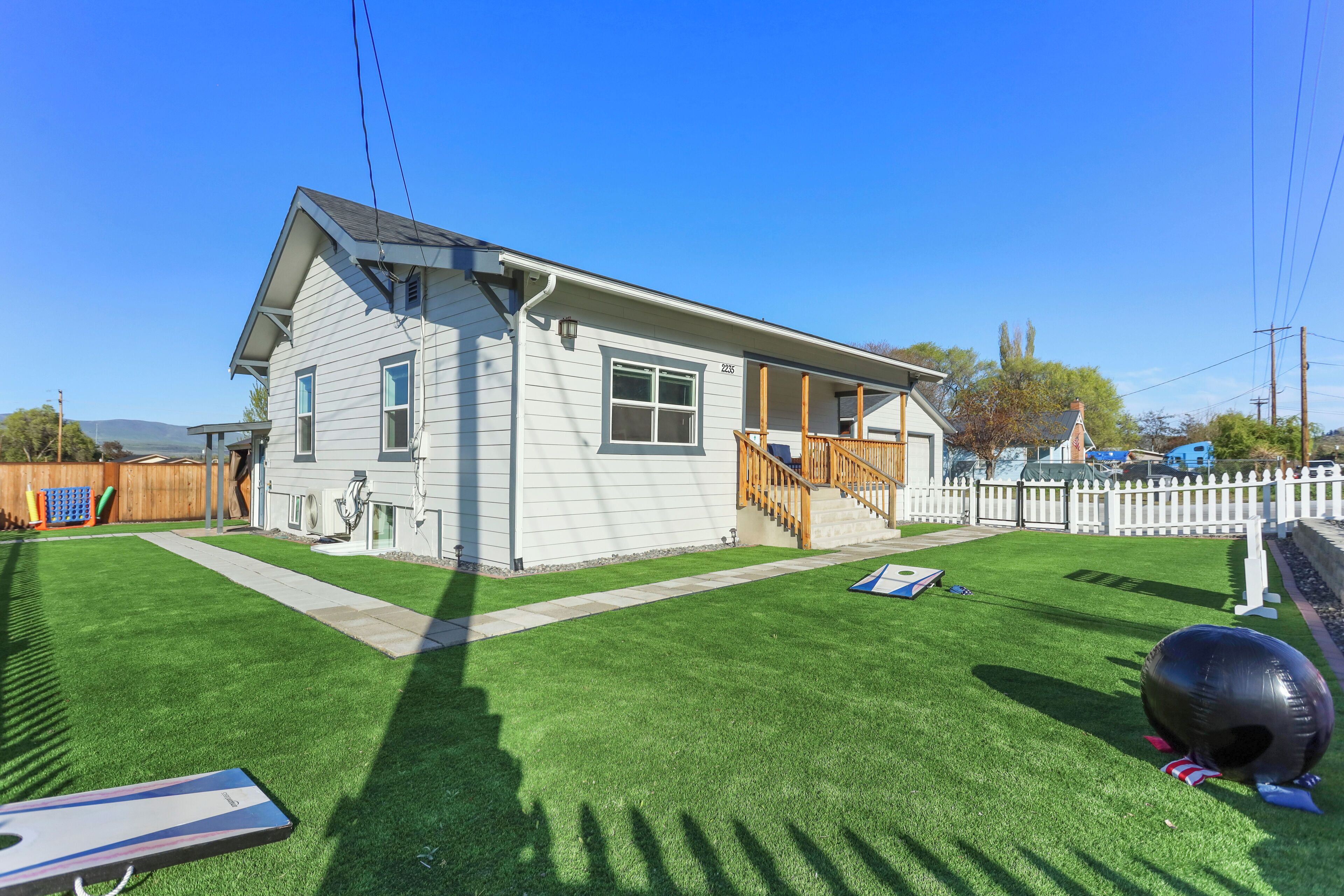 A single-story house with a front porch and a small deck.