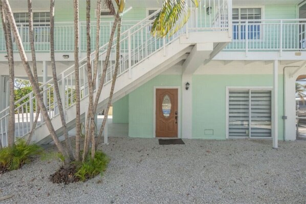 Two-story building with a staircase and a ground-floor entrance.