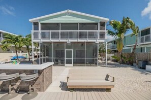 Enjoy the ocean views from the spacious balcony with a covered outdoor seating area and pool nearby.