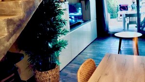 Ein modernes Interieur mit einer Treppe, einem Essbereich und einem großen Fenster.