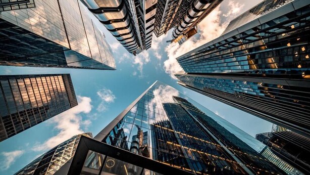 A high-rise building with a modern glass facade and a unique angular design.