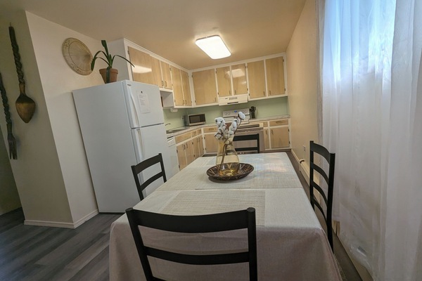 Fully equipped kitchen w/ organized storage & flow seamlessly to dining area.