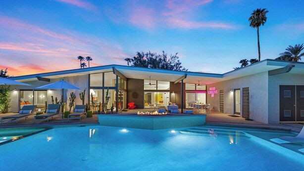 A modern house with a swimming pool, outdoor seating, and a neon sign. - California Retro - 1963 Gem on 1/2 an Acre (Palm Desert)