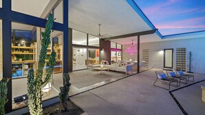 A modern house with a spacious patio, a dining area, and a living room. - California Retro - 1963 Gem on 1/2 an Acre (Palm Desert)