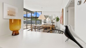 A modern dining area with a large table, chairs, and a view of the outdoors. - California Retro - 1963 Gem on 1/2 an Acre (Palm Desert)
