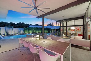 A modern outdoor patio with a pool, seating area, and ceiling fan. - California Retro - 1963 Gem on 1/2 an Acre (Palm Desert)