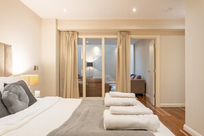 Relax in this inviting room with a comfortable bed, crisp towels, and a balcony offering a view of the outside.