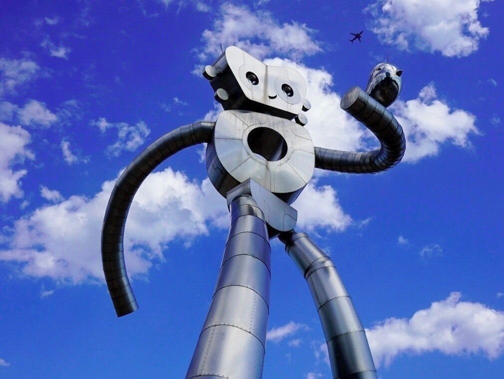A must see when visiting Dallas. Located at Good Latimer and Swiss Avenue, is 38’ Traveling Man “Walking Tall.” The Traveling Man towers over Deep Ellum, and he's in the middle of taking big strides with a smile on his face, a bird on his arm and a hole in the middle of his chest.