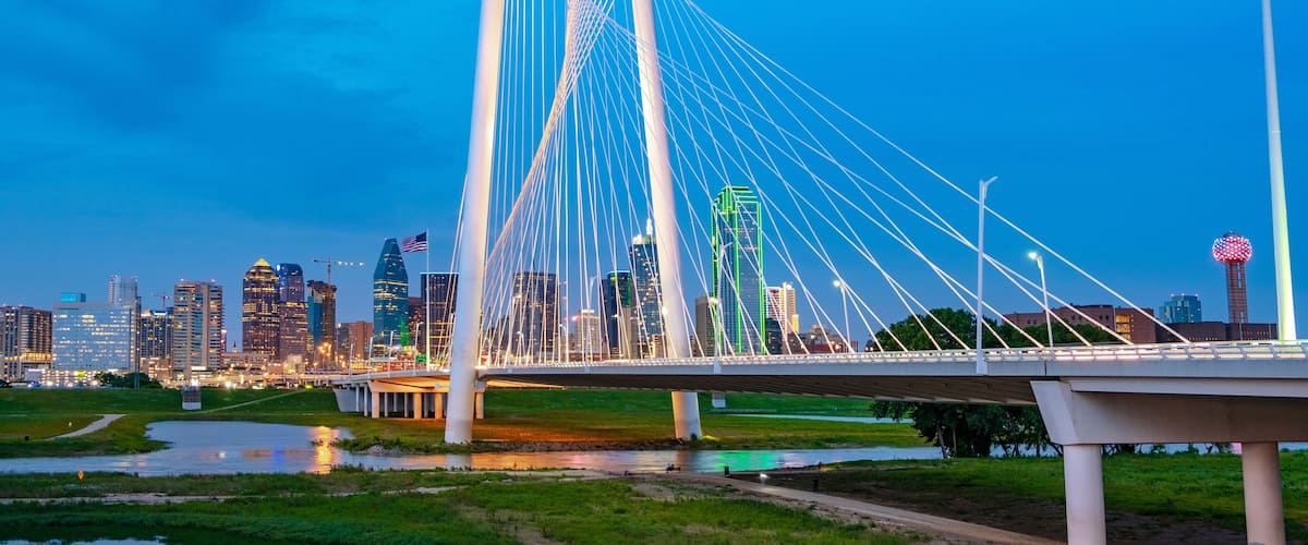 A cable-stayed bridge with a city skyline in the background.