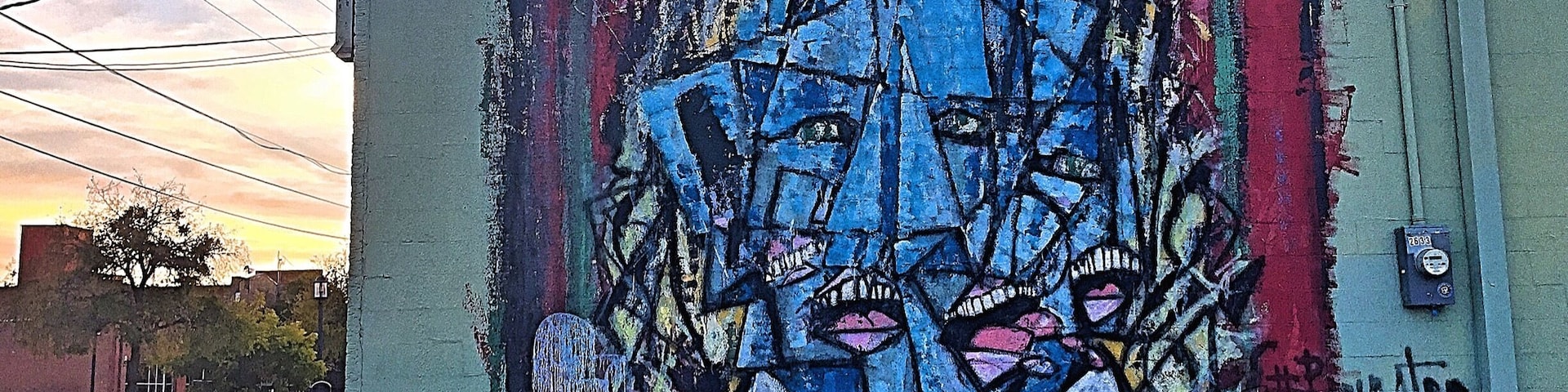 Part of Deep Ellum's street art project. This guy is split on a #red background. Cubism feels.