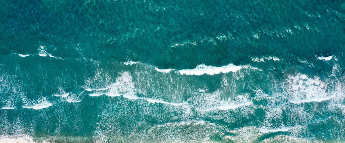 A beach with waves crashing onto the shore.