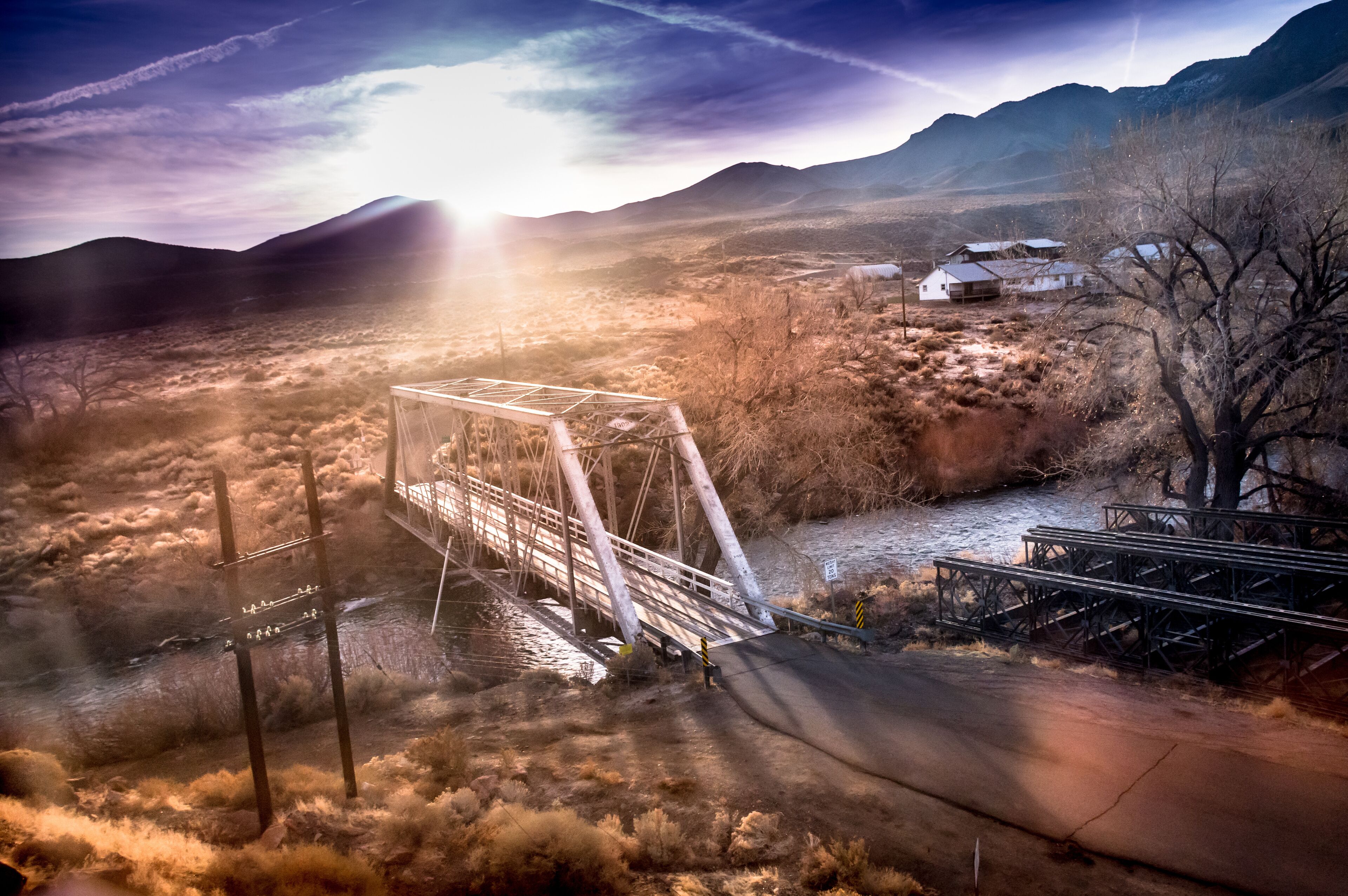 Bridge over the Truckee River at sunrise, Fernley, NV. Sun breaking over mountains.