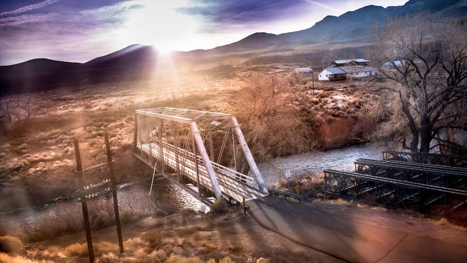 Bridge over the Truckee River at sunrise, Fernley, NV. Sun breaking over mountains.