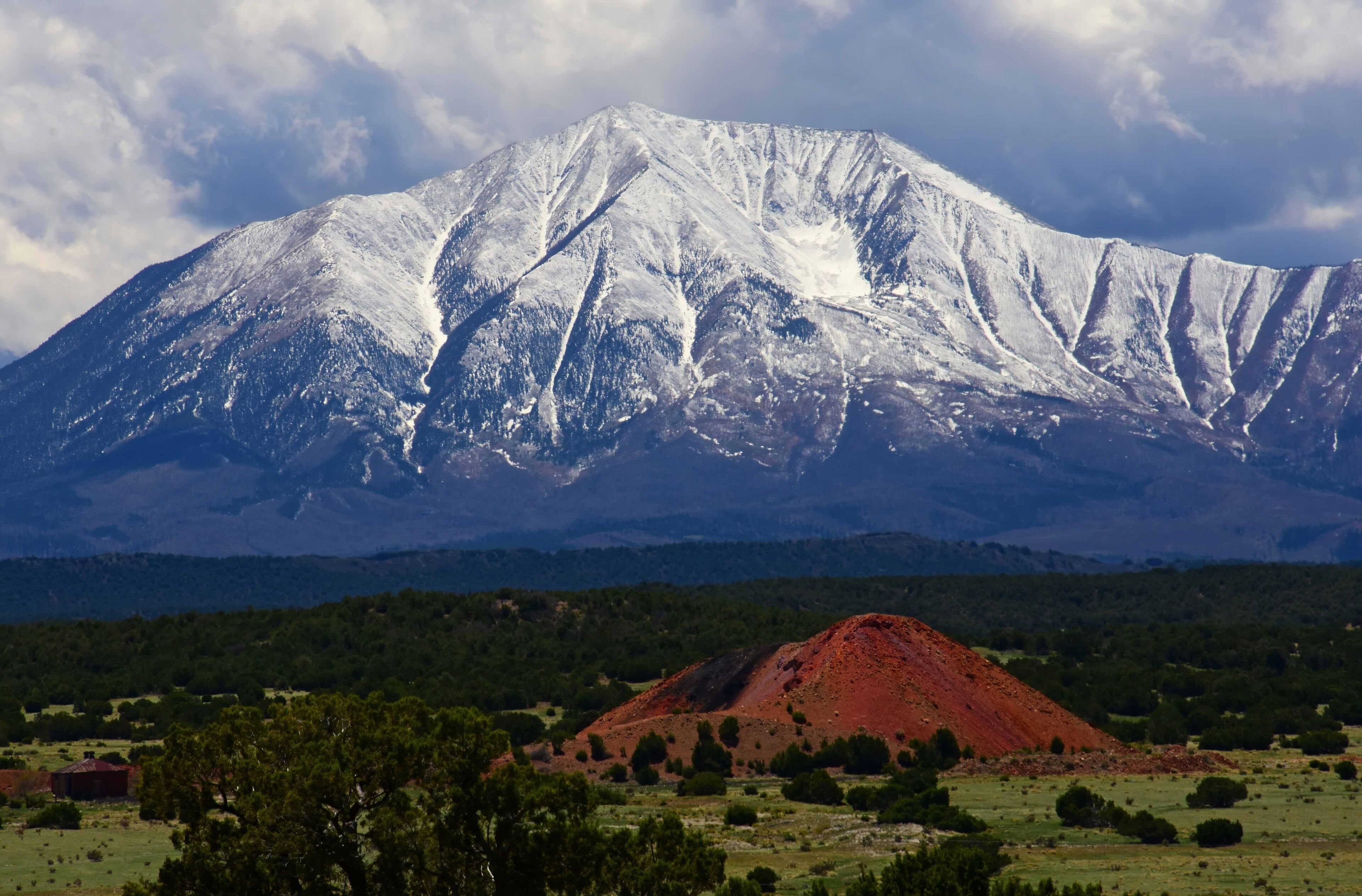 the dramatic, snow- capped east spanish peak in  the rocky mountains of southern colorado  on a spring day , near walsenburg 